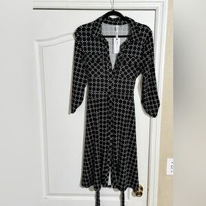 Black and white polyester knee length button down dress.